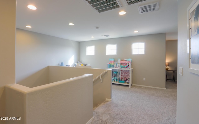 corridor with light colored carpet