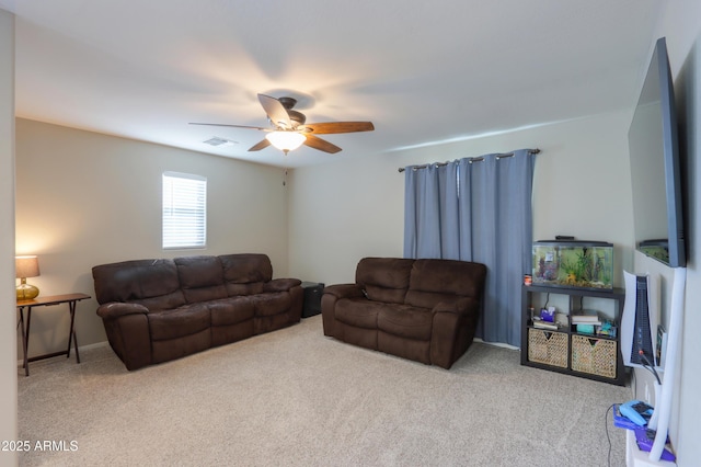 carpeted living room with ceiling fan