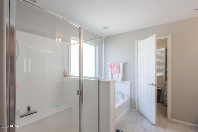 bathroom featuring tile patterned flooring and shower with separate bathtub