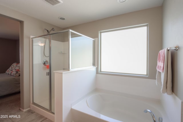 bathroom featuring independent shower and bath