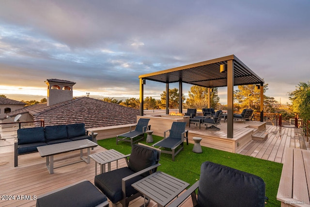 deck at dusk with a lawn and outdoor lounge area