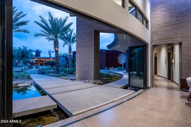 view of patio / terrace featuring a swimming pool and a balcony