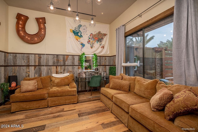 living room featuring light hardwood / wood-style floors and wood walls