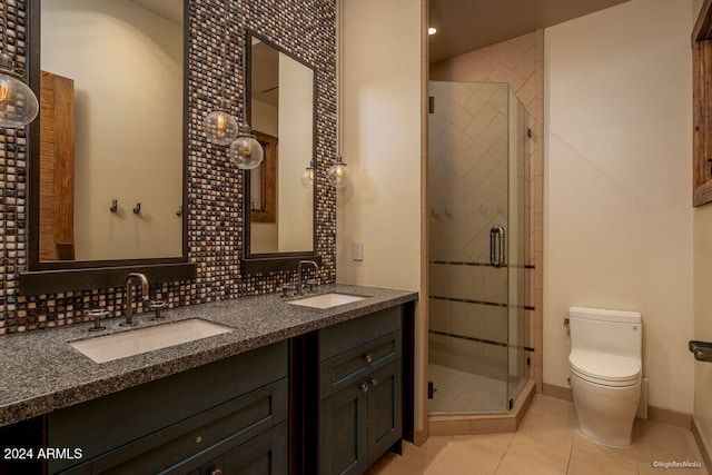 bathroom with backsplash, vanity, toilet, and an enclosed shower