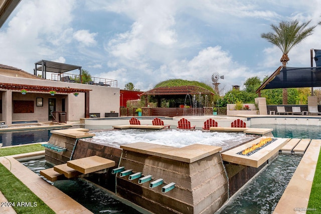 view of swimming pool featuring pool water feature, exterior bar, a patio area, and a jacuzzi