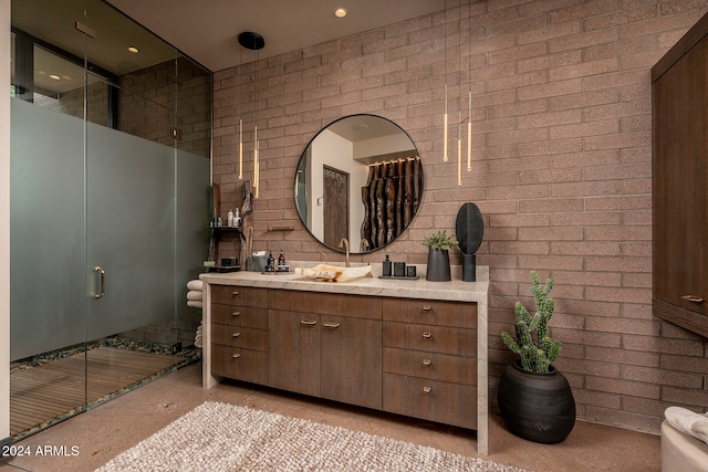 bathroom with vanity, brick wall, and an enclosed shower