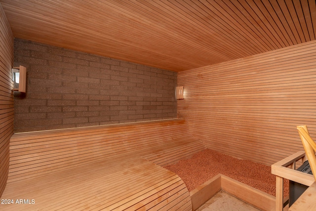 view of sauna with wood walls and wooden ceiling