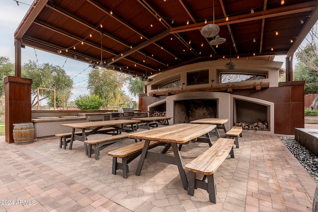 view of patio / terrace with exterior fireplace