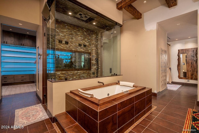 bathroom featuring a towering ceiling, beamed ceiling, independent shower and bath, and tile patterned flooring