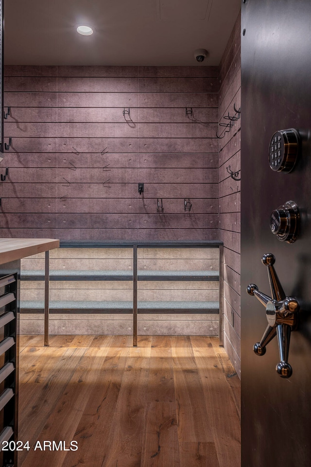 bathroom featuring hardwood / wood-style floors and wood walls