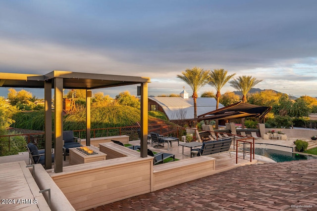 view of patio / terrace with an outdoor living space with a fire pit