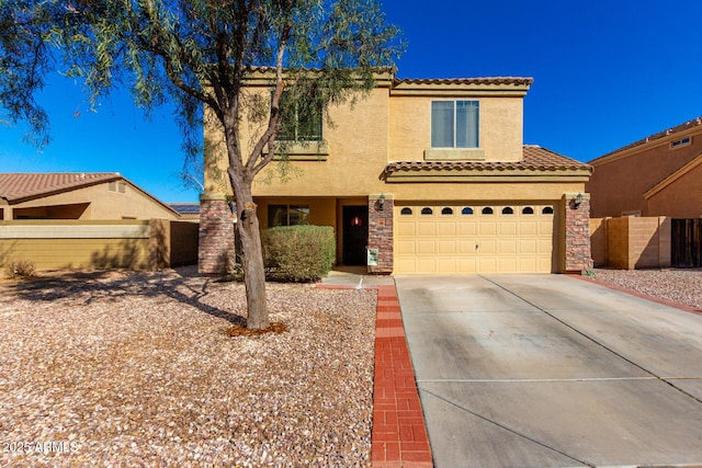 mediterranean / spanish-style house with driveway, stone siding, a tiled roof, and stucco siding