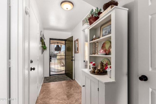 entryway featuring light tile patterned floors and baseboards