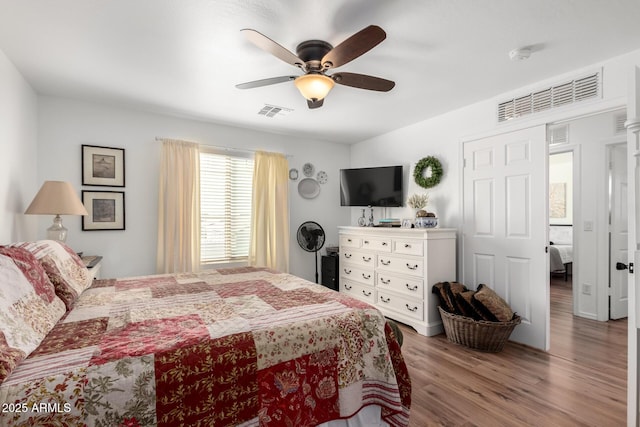 bedroom with visible vents, ceiling fan, and wood finished floors