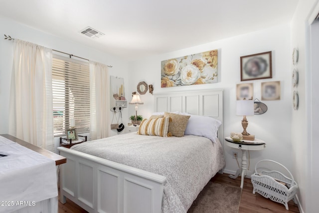 bedroom featuring dark wood-style floors and visible vents