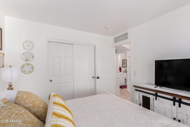 bedroom with a closet and visible vents