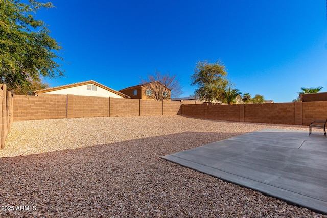 view of yard featuring a patio and a fenced backyard