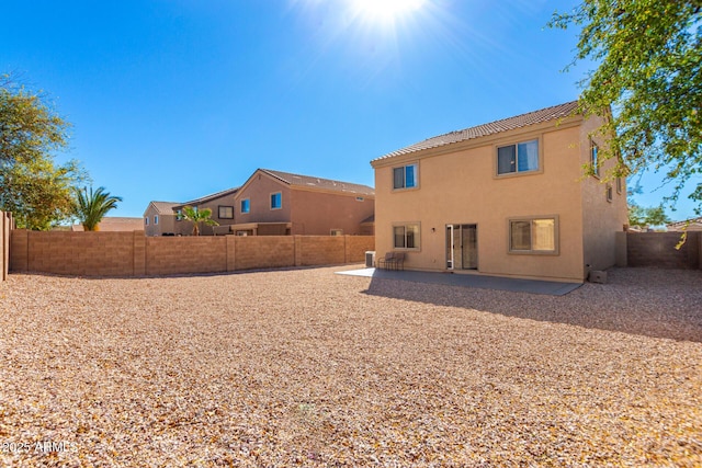 back of property with a patio area, a fenced backyard, and stucco siding