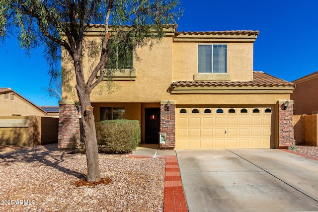 mediterranean / spanish-style home with a tile roof, stucco siding, a garage, stone siding, and driveway