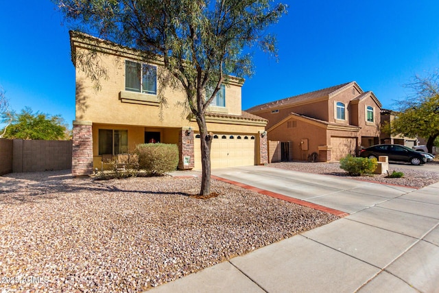 view of front of house featuring a garage, fence, concrete driveway, and stucco siding