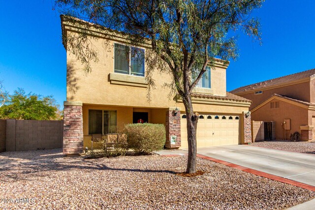 view of front of property featuring stucco siding, fence, stone siding, driveway, and a tiled roof