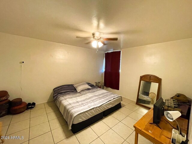 bedroom with ceiling fan and light tile patterned floors