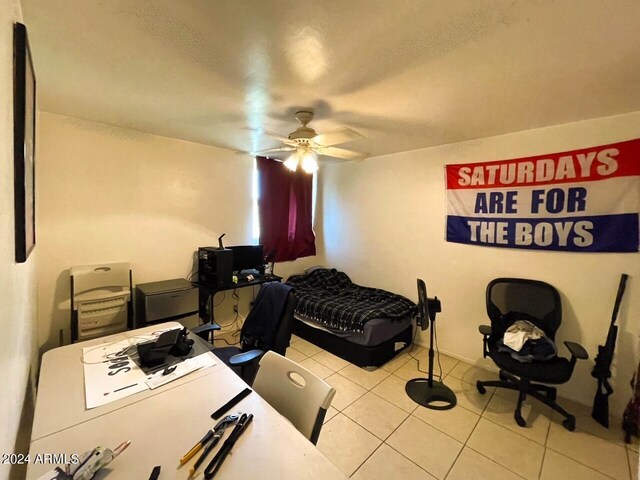 bedroom with ceiling fan and light tile patterned floors