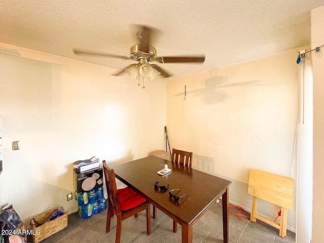 office space with a textured ceiling, ceiling fan, and tile patterned floors