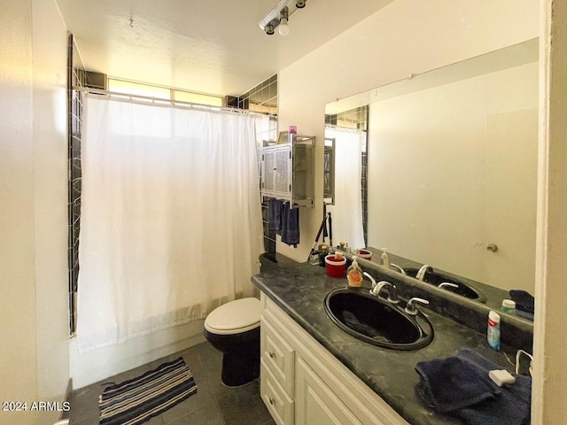 bathroom with tile patterned flooring, vanity, and toilet