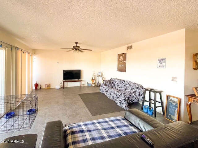 tiled living room featuring a textured ceiling and ceiling fan