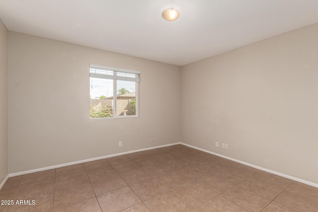 empty room featuring baseboards