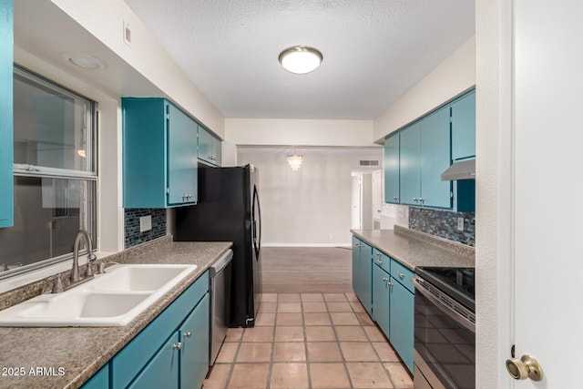 kitchen featuring blue cabinetry, backsplash, under cabinet range hood, stainless steel appliances, and a sink