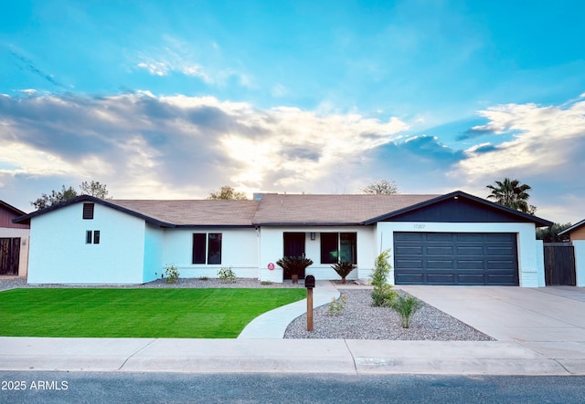 single story home featuring a front yard and a garage