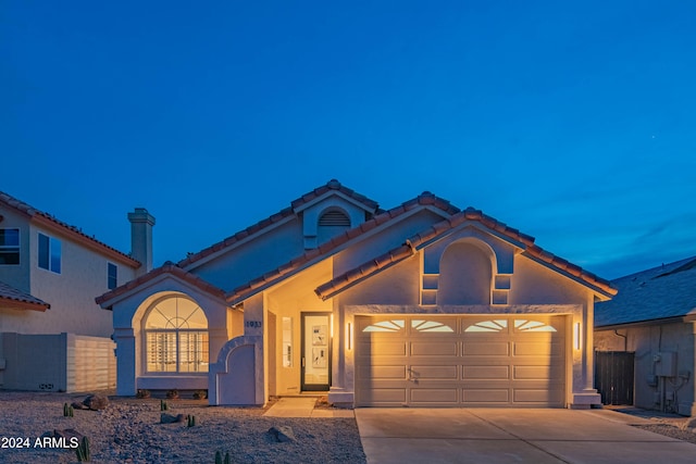 mediterranean / spanish-style house featuring a garage