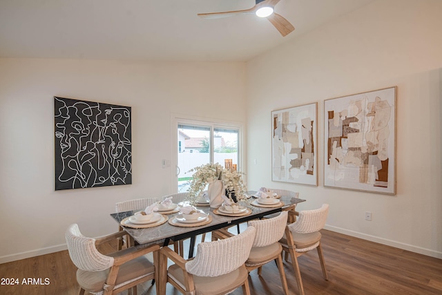 dining room featuring dark hardwood / wood-style floors, ceiling fan, and vaulted ceiling