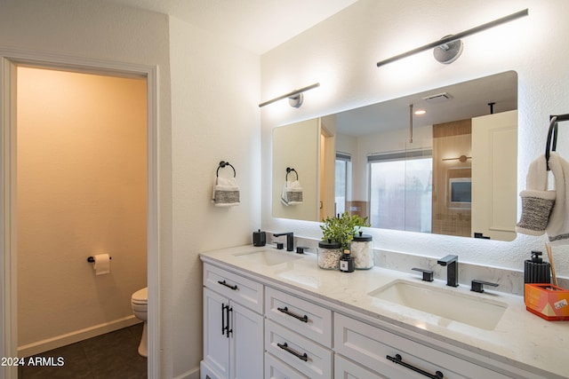 bathroom with tile patterned flooring, vanity, and toilet