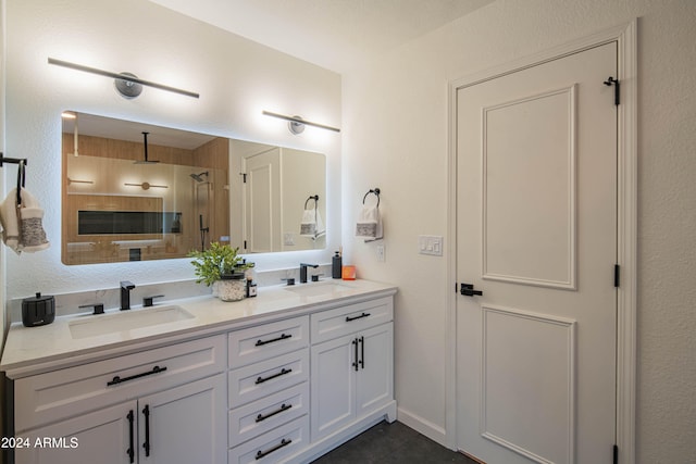 bathroom featuring tile patterned flooring, vanity, and walk in shower