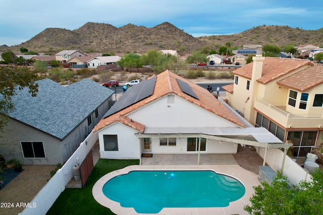 view of pool featuring a mountain view and a patio