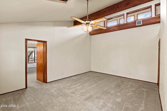 carpeted spare room with vaulted ceiling with beams and ceiling fan