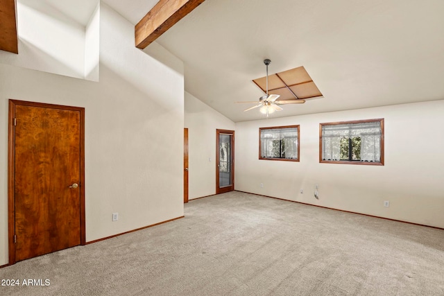 carpeted empty room featuring vaulted ceiling with beams and ceiling fan