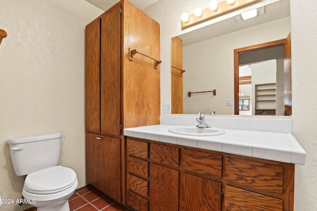 bathroom with tile patterned floors, vanity, and toilet