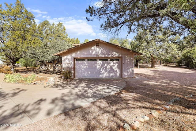 view of property exterior featuring a garage and an outbuilding