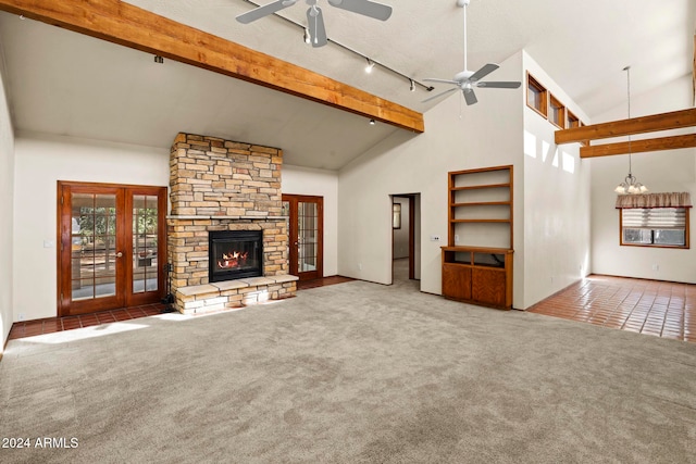 unfurnished living room featuring carpet, french doors, and high vaulted ceiling