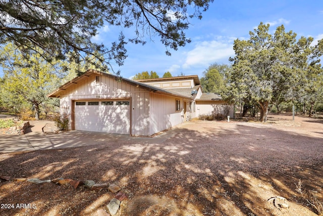 view of side of home featuring a garage