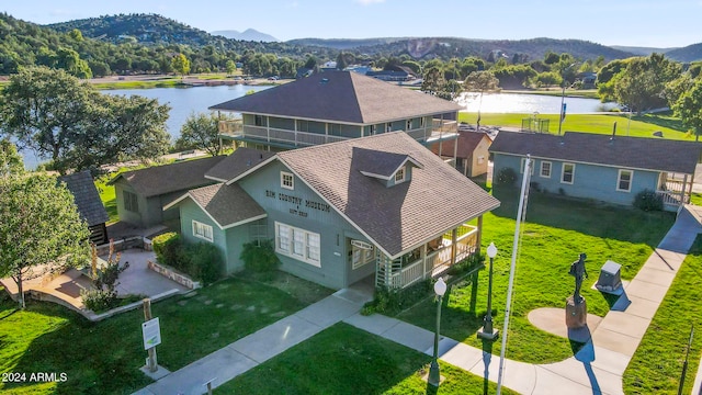 birds eye view of property featuring a water and mountain view