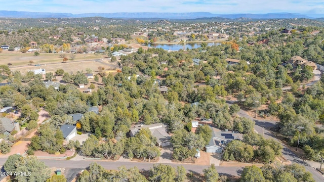 drone / aerial view featuring a water and mountain view