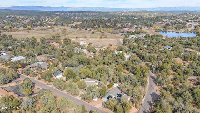 drone / aerial view featuring a water and mountain view