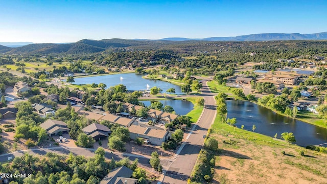 aerial view featuring a water and mountain view