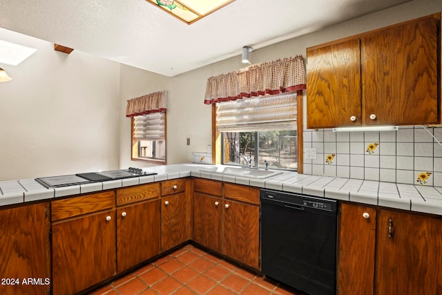 kitchen with sink, gas stovetop, black dishwasher, tile countertops, and decorative backsplash