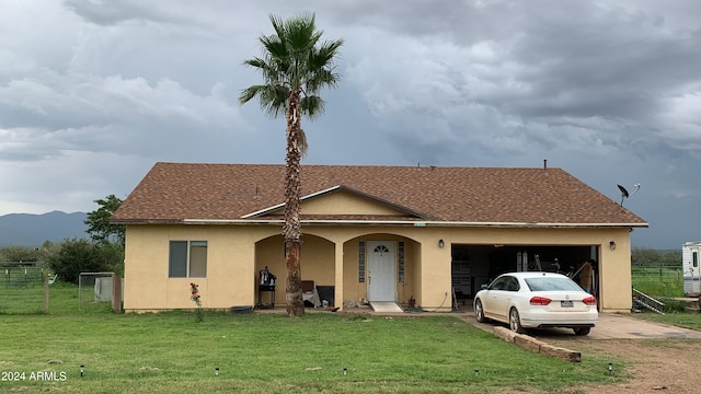 view of front of property featuring a garage, a front lawn, concrete driveway, and stucco siding